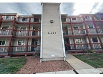 Three-story condo building with multiple balconies and manicured landscaping, showing curb appeal at 8645 Clay St # 400, Westminster, CO 80031
