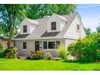 Charming two-story home with landscaped yard and a combination of lap siding and stucco at 1856 S Monroe St, Denver, CO 80210