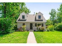 Charming home with a well-maintained front yard, blossoming roses, and inviting walkway at 1856 S Monroe St, Denver, CO 80210