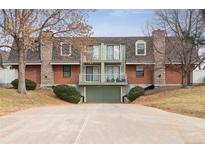 Two-story condo featuring brick and stone accents, balconies, and garage at 1390 S Idalia St # 39F, Aurora, CO 80017