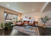 Bright and airy living room with large windows, a stylish rug, and comfortable seating at 6026 Iris Way, Arvada, CO 80004