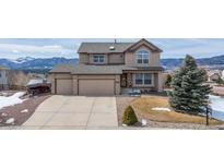 Charming two-story home with a two car garage and mountain views on a sunny day at 15640 Agate Creek Dr, Monument, CO 80132