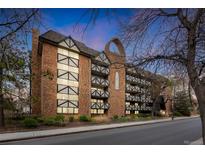 Charming brick condo building with balconies and Tudor-style accents, offering a unique and inviting curb appeal at 1350 Josephine St # 208, Denver, CO 80206