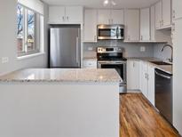 Modern kitchen with stainless steel appliances and granite countertops at 1085 N Lafayette St # 604, Denver, CO 80218