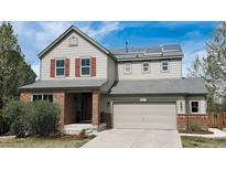 Charming two-story home featuring solar panels, a two-car garage, and a well-maintained front yard at 961 Stanley Ct, Erie, CO 80516