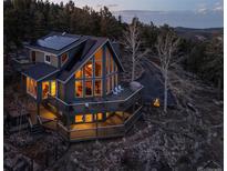 Stunning two-story home featuring multiple decks, large windows and mountain views at 13452 Riley Peak Rd, Conifer, CO 80433