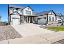 Stunning two-story home with a three-car garage and welcoming front porch at 3293 Offbeaten Pl, Castle Rock, CO 80108