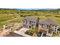 Lovely two-story home featuring a two-car garage, neutral paint, and beautiful landscaping at 2511 Loon Ln, Castle Rock, CO 80104