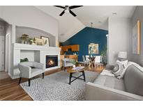 Inviting living room features a cozy fireplace, vaulted ceilings and an open floor plan, perfect for entertaining at 22580 E Ontario Dr # 204, Aurora, CO 80016