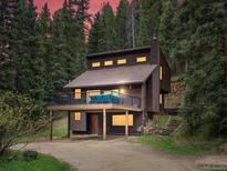 Inviting home with a spacious deck, set among towering trees at 28272 Shadow Mountain Dr, Conifer, CO 80433