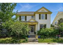 Charming two-story home with a landscaped front yard, steps and beautiful plants in a vibrant neighborhood at 8256 E 28Th Dr, Denver, CO 80238