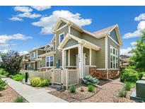 Charming home with a well-manicured lawn, stone accents, and a inviting front porch at 1190 Telleen Ave, Erie, CO 80516