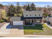 Charming two-story home featuring brick accents, a covered porch, and a spacious two-car garage at 9940 Pecos St, Thornton, CO 80260