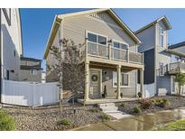 Charming home featuring a second story balcony, neat front yard with stone ground cover, and concrete steps leading to the front door at 18270 E 51St Pl, Denver, CO 80249