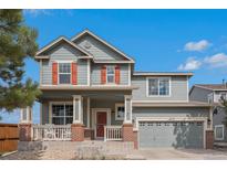 Charming two-story home featuring a welcoming front porch and a well-maintained lawn in a desirable neighborhood at 2470 Robindale Way, Castle Rock, CO 80109