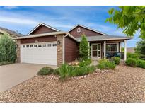 Charming single-Gathering home with a well-manicured lawn, stone accents, and a two-car garage at 12888 Buckhorn Creek St, Parker, CO 80134