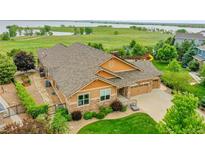 Aerial view of the property showcasing lush landscaping and neighborhood setting at 26631 E Arbor Dr, Aurora, CO 80016