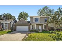 Charming two-story home featuring a well-manicured lawn and a two car garage, perfect for a Gathering at 10064 Owens St, Broomfield, CO 80021