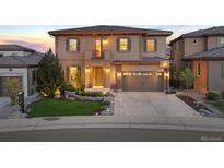 Charming two-story home with a manicured lawn, two-car garage, and a basketball hoop on the driveway at 10601 Montecito Dr, Lone Tree, CO 80124