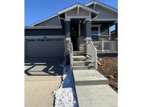 Two-story Craftsman style home with stone accents and a two-car garage at 5124 N Quemoy St, Aurora, CO 80019