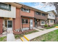 Charming brick townhome with a well-maintained front yard and inviting entrance at 12662 W Virginia Ave, Lakewood, CO 80228