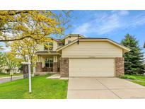 Charming two-story home featuring a well-manicured lawn and an attached two-car garage at 20532 E Lake Cir, Centennial, CO 80016