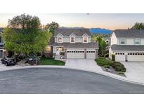 Charming two-story home with a well-manicured lawn and a three-car garage at 6973 Daventry Pl, Castle Pines, CO 80108