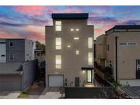 Modern three-story home featuring clean lines, large windows, and a sleek exterior design at 2607 W 24Th Ave, Denver, CO 80211