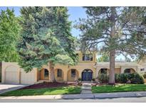 Charming two-story home with well-maintained lawn and mature trees enhancing curb appeal at 7504 E Jefferson Dr, Denver, CO 80237