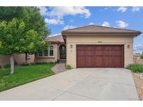 Charming single-story home featuring a well-manicured lawn, a two-car garage, and a welcoming entrance at 4775 S Anaheim Ct, Aurora, CO 80015