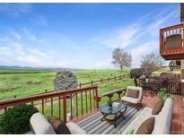 Relax on the expansive deck with gorgeous views of the green landscape and blue skies at 4603 S Abilene Cir, Aurora, CO 80015