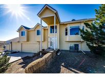 Charming two-story home with a large front porch and attached two-car garage in a rural setting at 7440 S Shenandoah Dr, Elizabeth, CO 80107