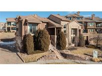 Multi-story home with stone accents, well-maintained landscaping, and a welcoming front entrance at 9228 Sori Ln, Highlands Ranch, CO 80126