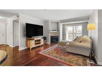 Cozy living room with a fireplace, hardwood floors and light neutral color scheme at 12158 W Dorado Pl # 205, Littleton, CO 80127