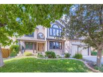 Inviting two-story home featuring a manicured lawn and mature trees in a desirable neighborhood at 16247 E Belleview Pl, Centennial, CO 80015