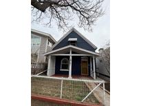 Charming blue home featuring a cozy front porch and a white picket fence at 3732 Navajo St, Denver, CO 80211