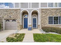 Charming townhouse facade with stone accents, arched entryways, and well-maintained landscaping at 4221 S Blackhawk Cir # 7G, Aurora, CO 80014