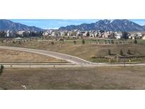 Beautiful neighborhood view with green spaces, walking trails, and mountain views at 3223 Castle Peak Ave, Superior, CO 80027