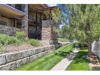 Multi-story condo with brick facade and well-maintained landscaping at 875 E 78Th Ave # 7, Denver, CO 80229