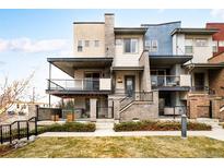Stunning multi-story home featuring modern architecture and a spacious outdoor living area with a large, covered balcony at 1004 Maria Ln, Louisville, CO 80027