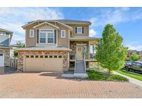Beautiful two-story home with a brick driveway and a two-car garage at 240 S Oak Hill St, Aurora, CO 80018