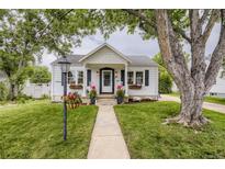 Charming home with beautiful landscaping, flower boxes, rocking chairs, and a welcoming entrance at 2634 S Humboldt St, Denver, CO 80210