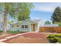Charming single-story home featuring a well-maintained lawn, shutters, and inviting curb appeal at 1892 S Fairfax St, Denver, CO 80222