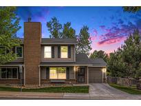 Charming two-story home showcasing a brick chimney, covered entryway, and attached one-car garage at 4116 W 111Th Cir, Westminster, CO 80031
