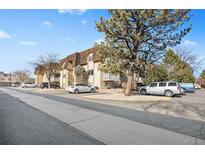 Attractive exterior of a multi-unit building with ample parking at 7455 E Quincy Ave # 204, Denver, CO 80237