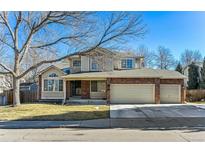 Charming two-story home with a brick facade and a three-car garage at 1642 S Trenton St, Denver, CO 80231