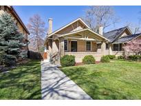 Charming brick home with a well-manicured front yard and inviting front porch at 1111 S Corona St, Denver, CO 80210