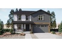 Charming two-story home with a covered porch and gray two-car garage at 22094 E 39Th Pl, Aurora, CO 80019