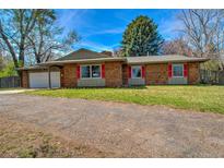 Charming brick home with a well-maintained lawn and bright red window shutters at 1705 Stonehenge Dr, Lafayette, CO 80026
