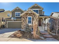 Charming two-story home with stone accents, well-maintained landscaping, and a basketball hoop over the garage at 2903 Dragonfly Ct, Castle Rock, CO 80109